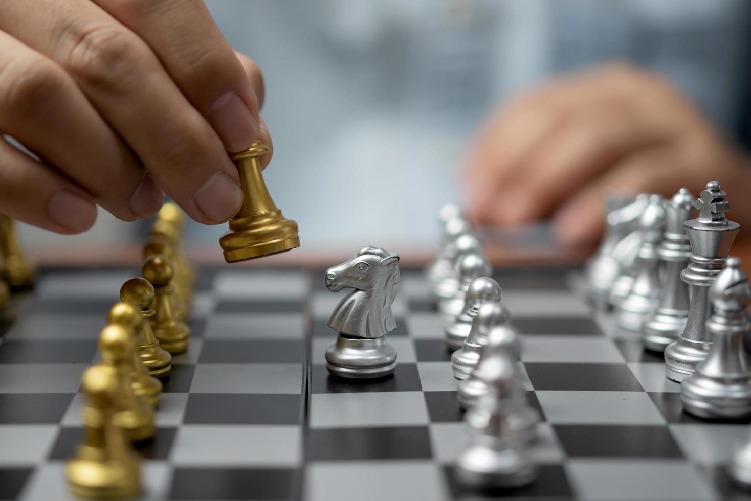 Businessman play on chess board game for ideas and competition and strategy success, business competition planing teamwork management or leadership concept. photo