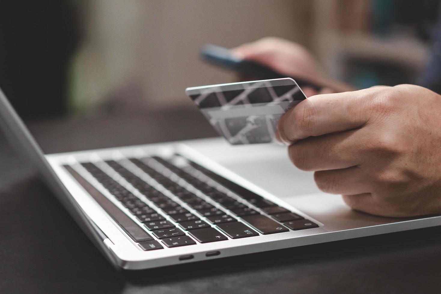 man paying and shopping with smartphone application e commerce wallet app technology. Man using mobile phone and credit card paying via mobile banking. photo