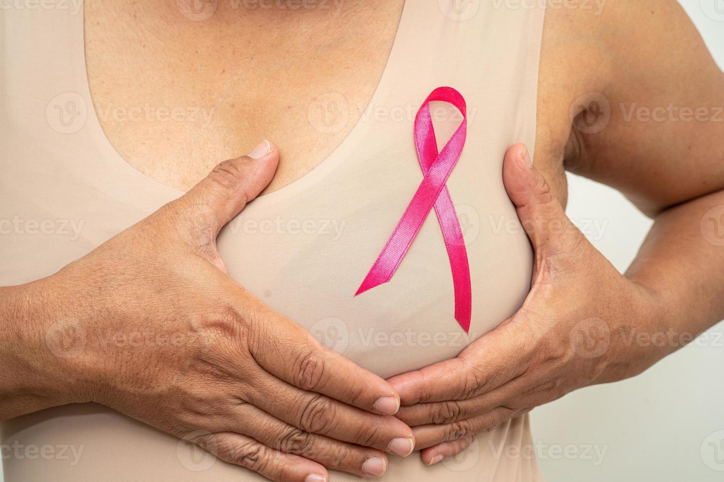 Breast cancer, pink ribbon at Asian senior lady for supporting awareness, symbol of World Breast Cancer Day. photo