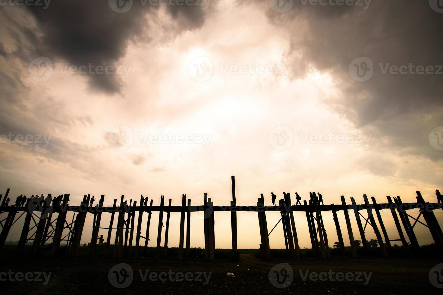 U Bein Bridge, the oldest and longest teakwood bridge in the world that crossing the Taungthaman lake near Amarapura, Myanmar photo