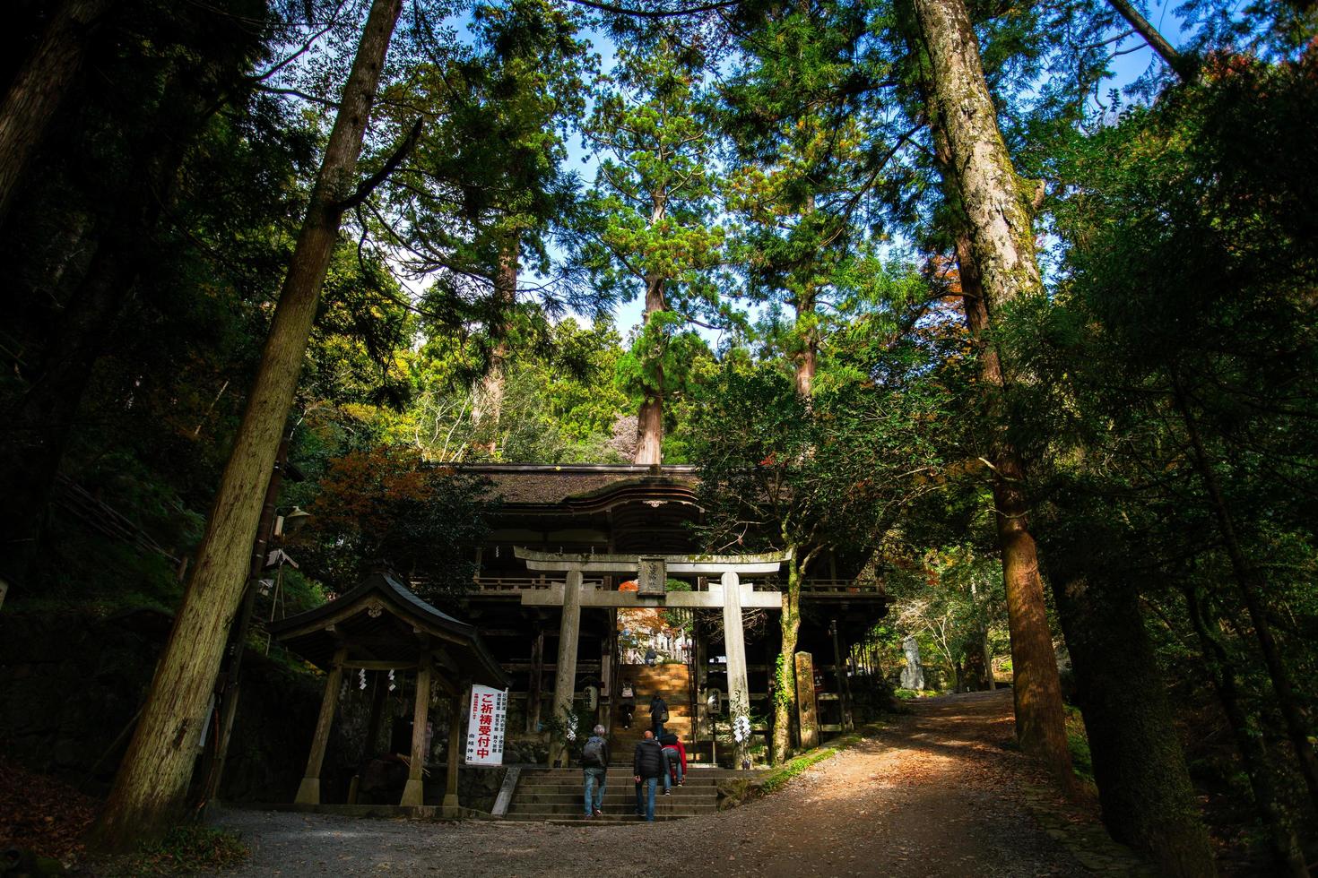 Kurama, Kyoto Prefecture, Kansai, Japan - November 21, 2019 - Tourists visit to Yuki-jinja, a famous Shinto shrine on the grounds of Kurama temple, a temple situated at the base of Mount Kurama photo