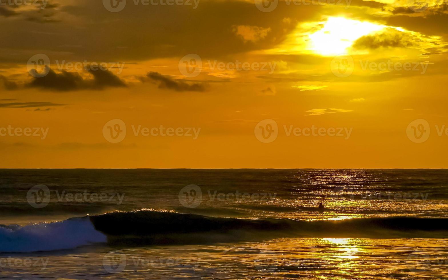 Colorful golden sunset big wave and beach Puerto Escondido Mexico. photo