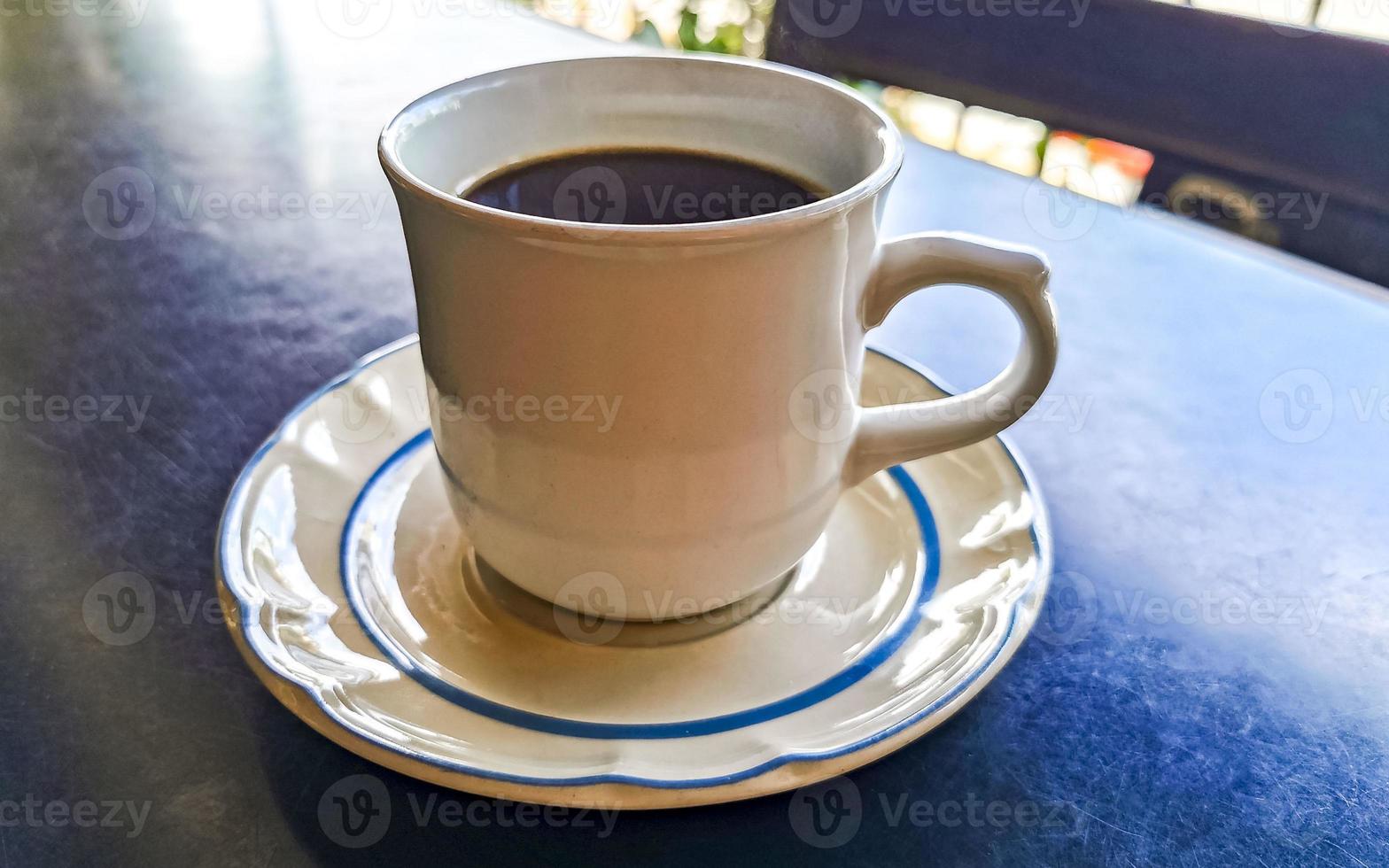 Cup of americano black coffee in restaurant Mexico. photo