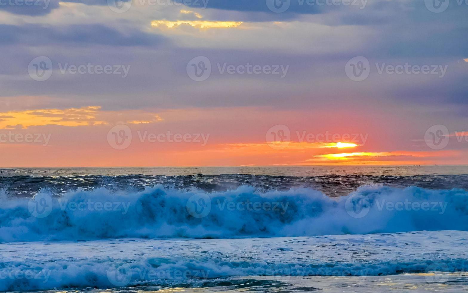 Colorful golden sunset big wave and beach Puerto Escondido Mexico. photo