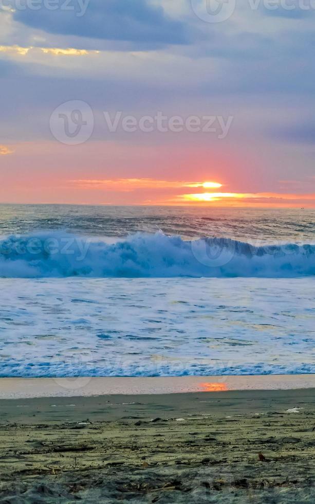 Colorful golden sunset big wave and beach Puerto Escondido Mexico. photo