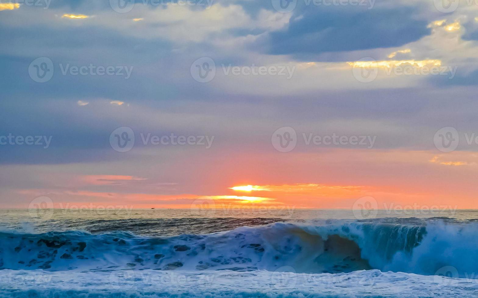 Colorful golden sunset big wave and beach Puerto Escondido Mexico. photo