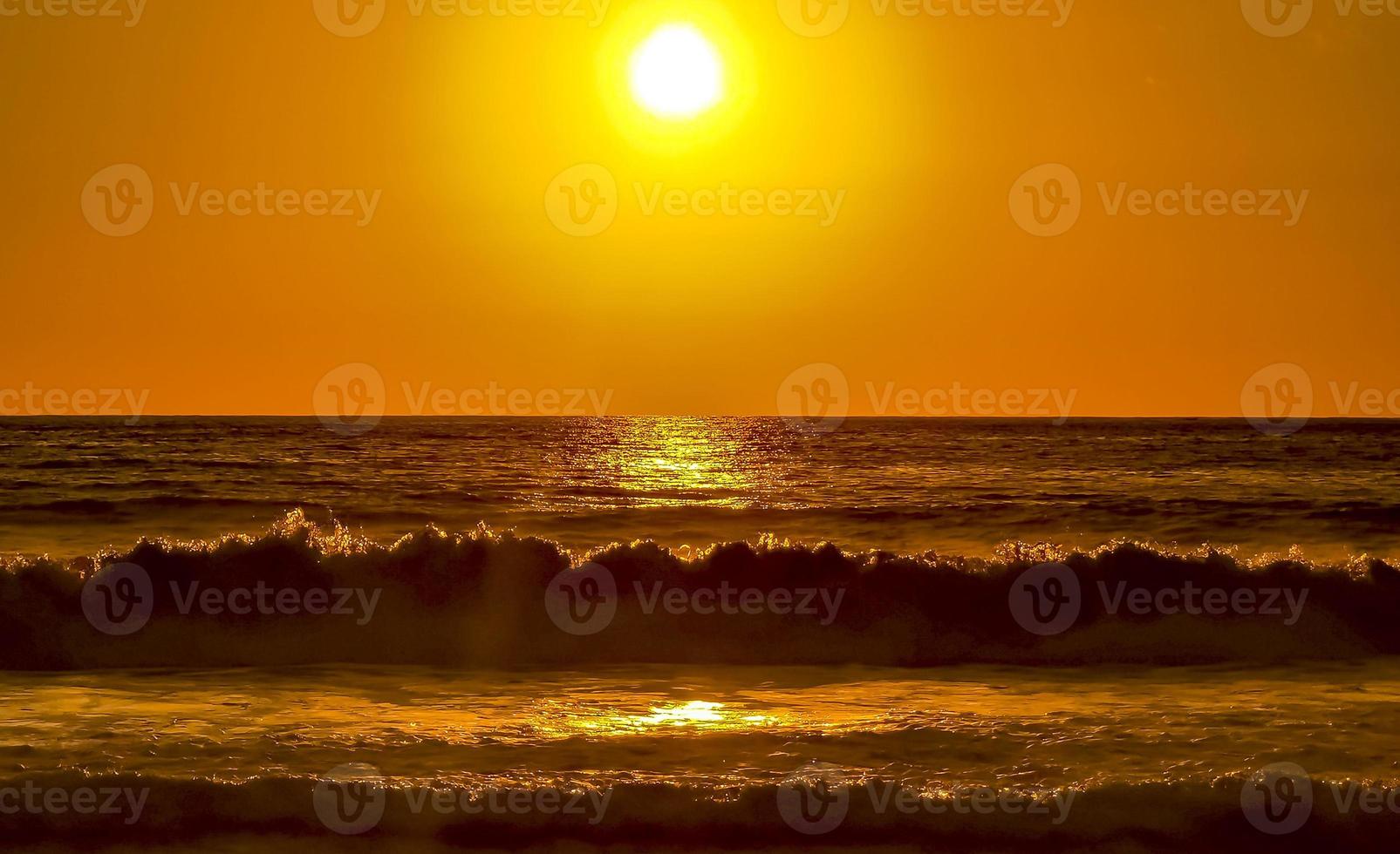 Colorful golden sunset big wave and beach Puerto Escondido Mexico. photo