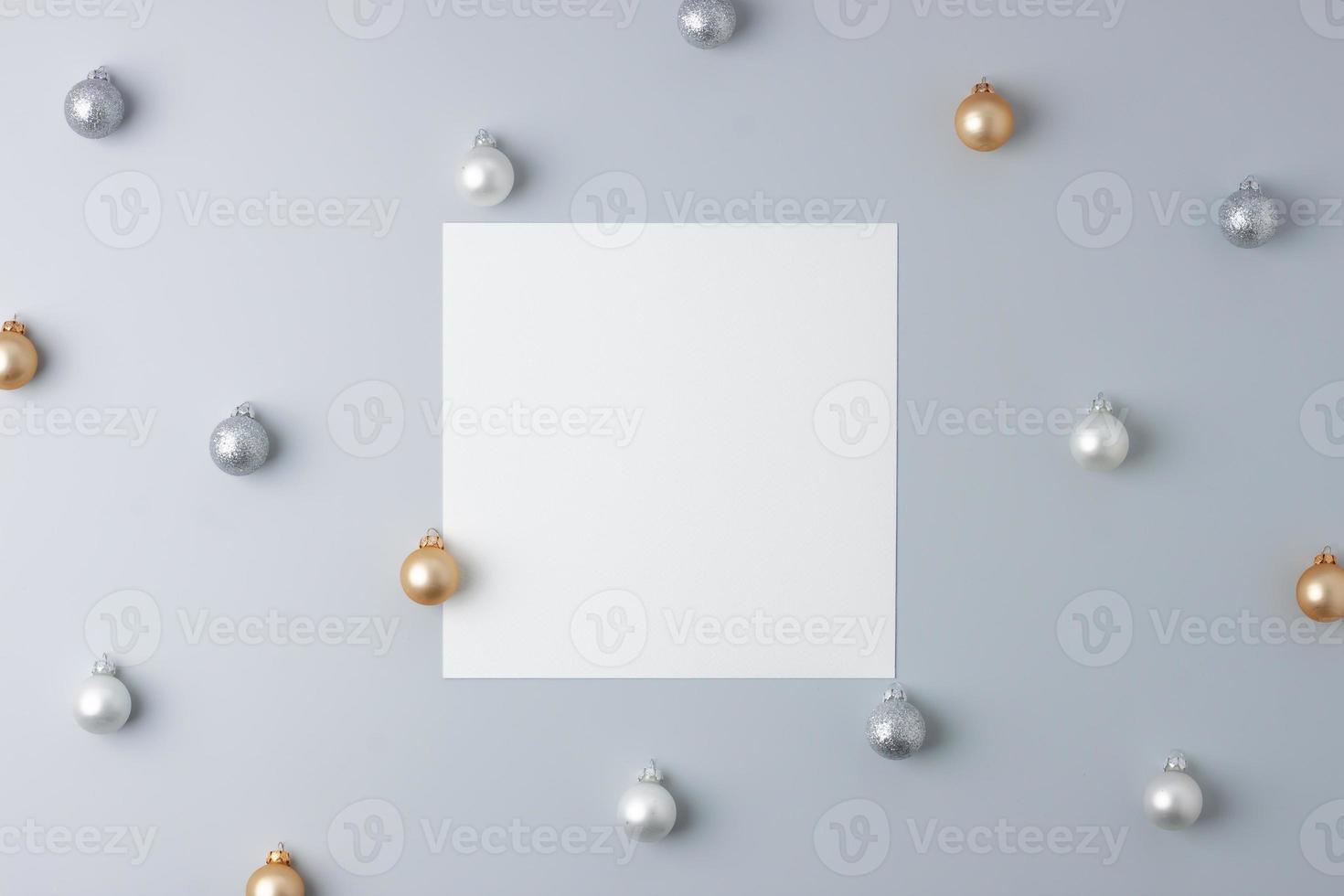 Christmas grey minimal background with mock up greetings card and ball. Flat lay, copy space photo