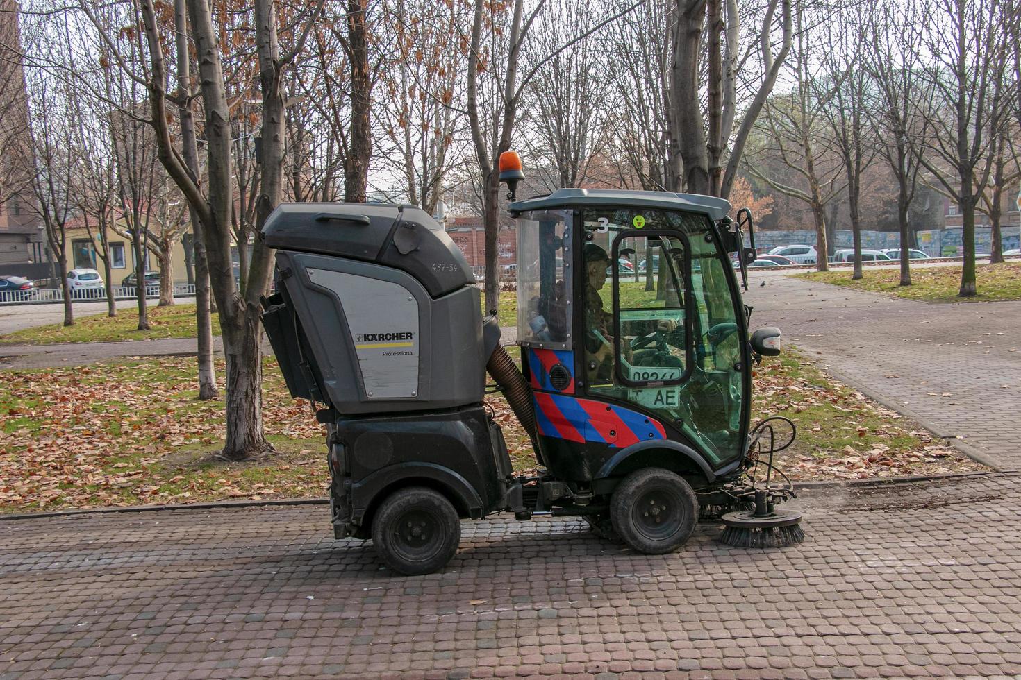 Dnepropetrovsk, Ukraine - 11.22.2021 Municipal service carries out seasonal works in the park. The brushes sweep the asphalt. photo