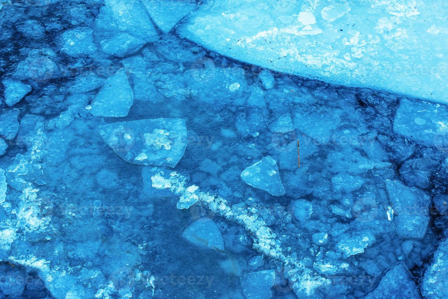 Winter nature background with blocks of ice on frozen water in spring. Abstract background of drifting ice on water photo