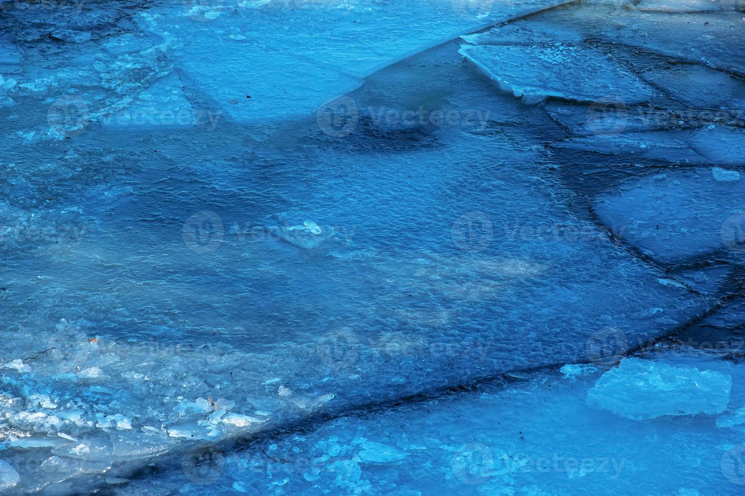 Winter nature background with blocks of ice on frozen water in spring. Abstract background of drifting ice on water photo