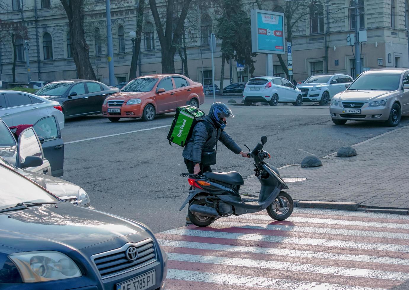 Dnepropetrovsk, Ukraine - 11.22.2021 Accident of two passenger cars due to wrong actions of a food delivery man on a moped. photo