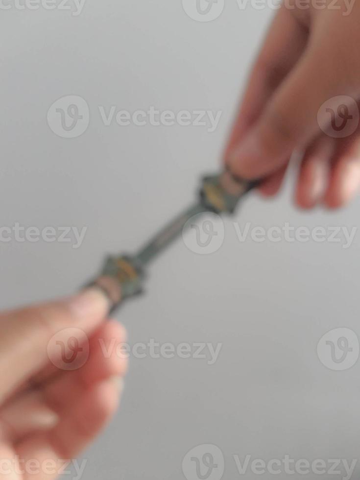 Jakarta, Indonesia in July 2021. A hand is holding a cable holder that functions to tidy up folded cables photo
