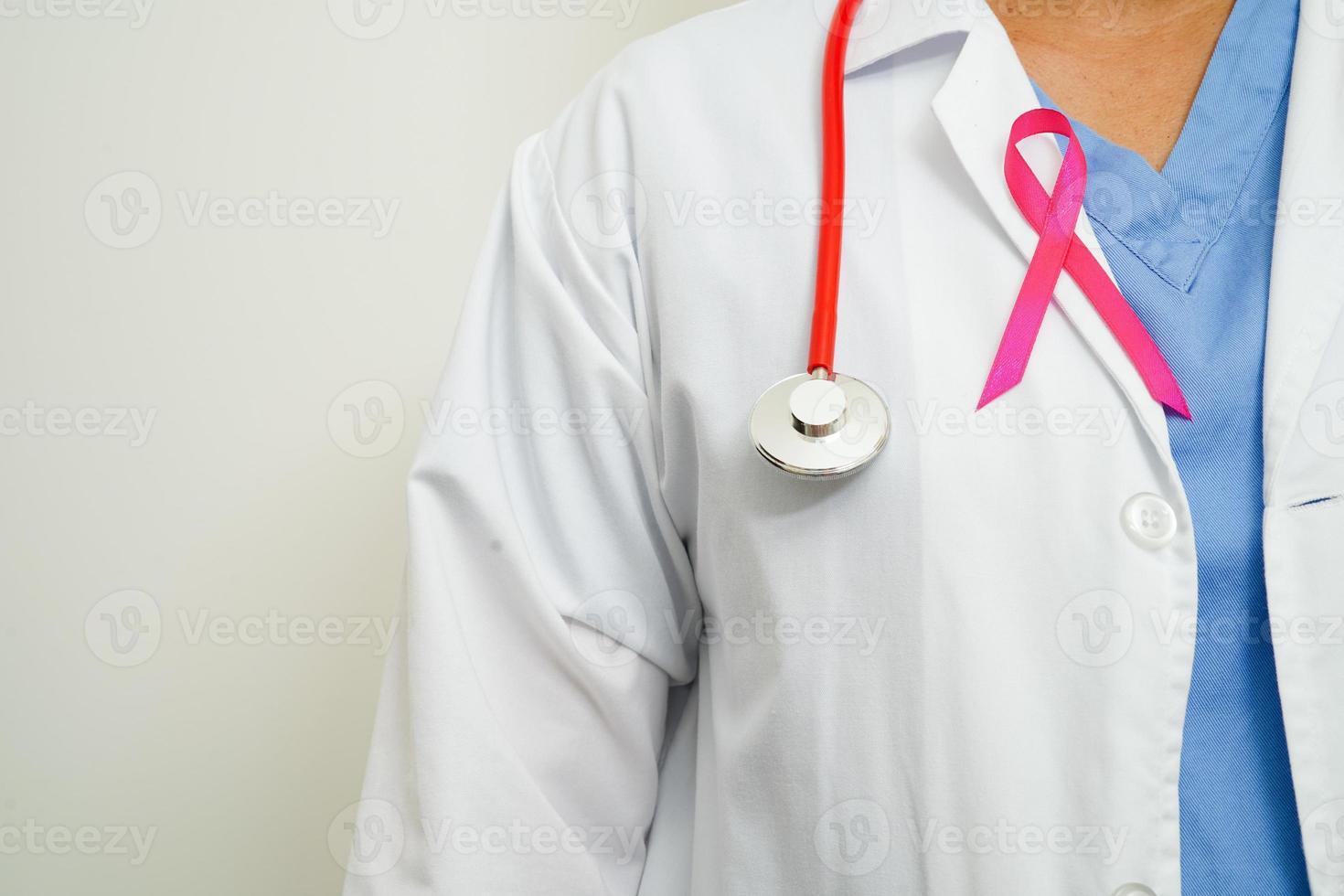 Asian woman doctor with pink ribbon, World Breast Cancer Day at October. photo