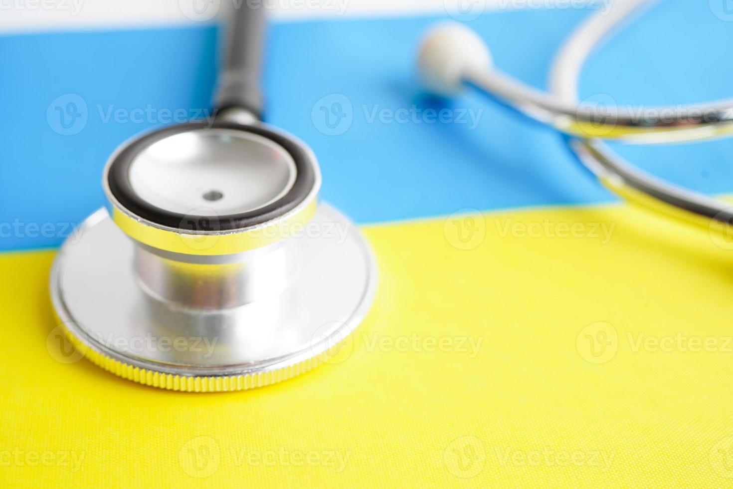 Black stethoscope on Ukraine flag background, Business and finance concept. photo