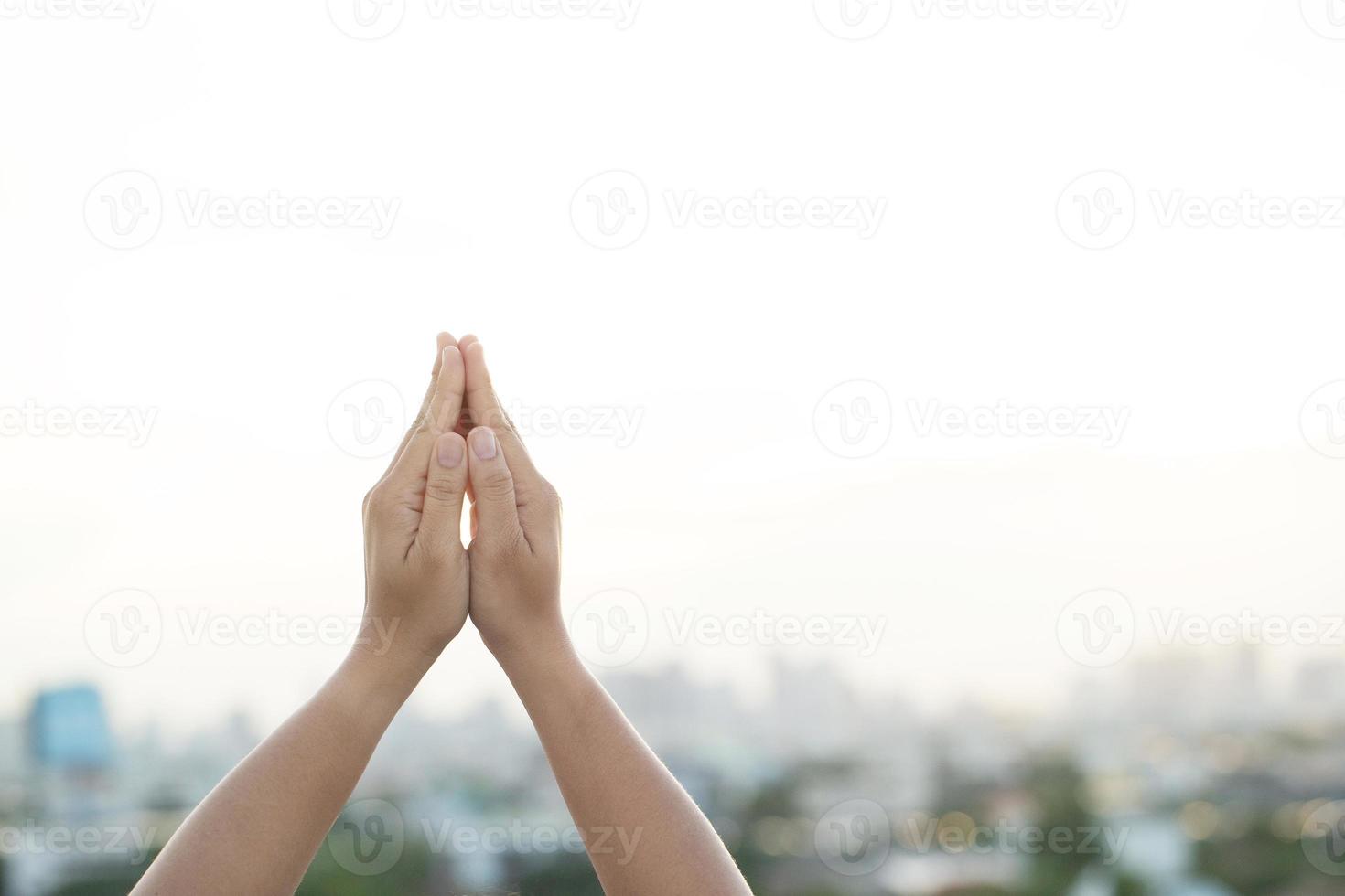 Women raise their hands to ask for blessing from God. photo