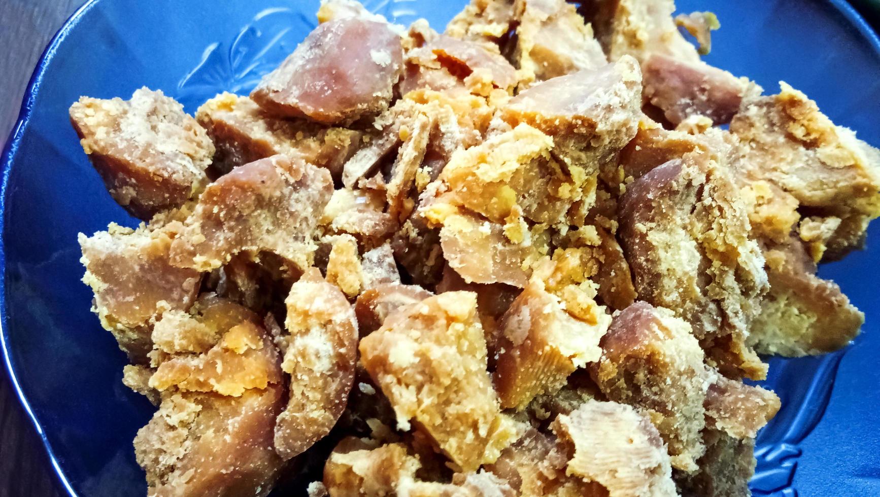 A close up shot of a bowl of Jaggery. photo