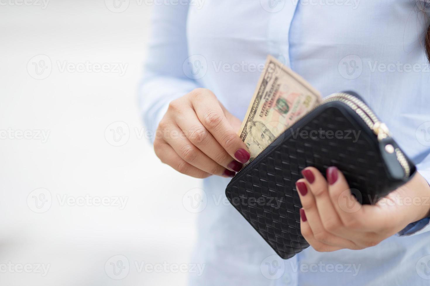 Woman holding a fashion wallet, she is shopping at a department store. photo