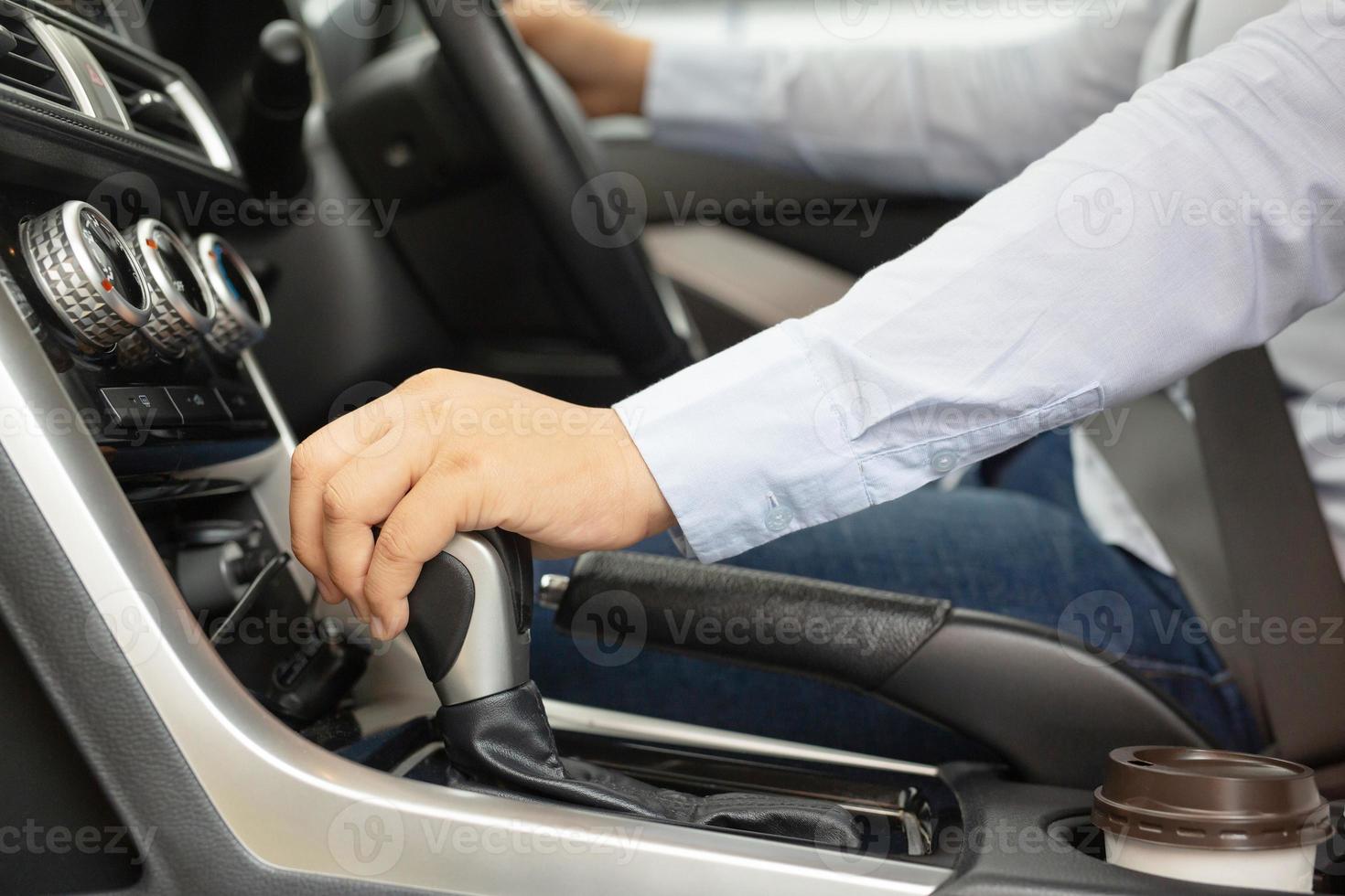 A woman parking a car with a hand brake for safety photo
