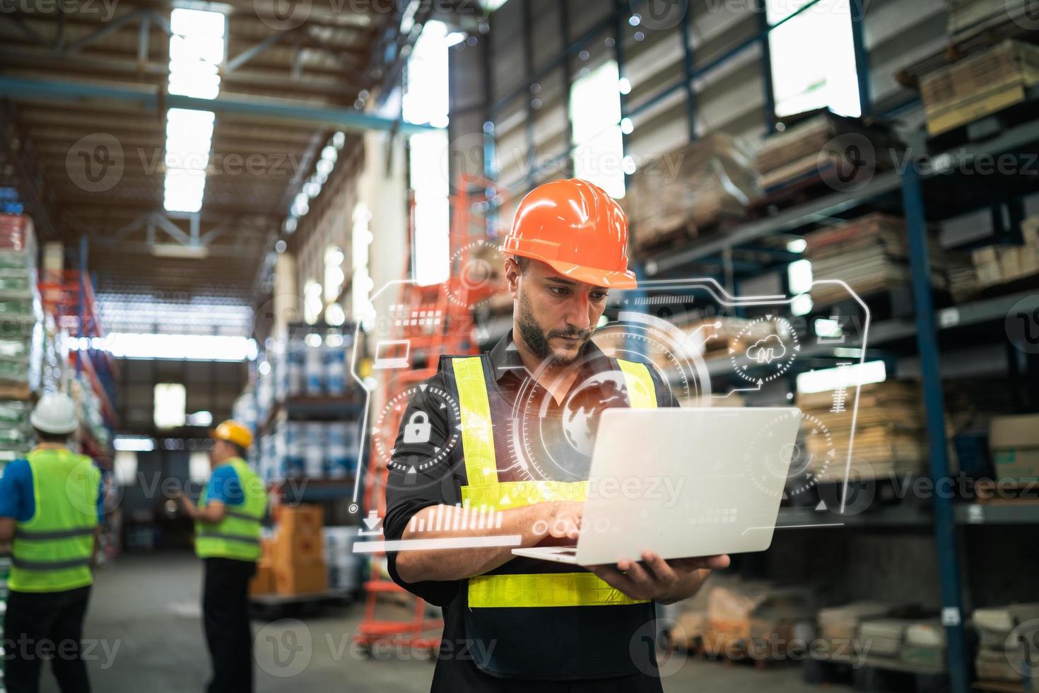 Professional manager man employee using laptop check stock working at warehouse. Worker wearing high visibility clothing and a hard hat, helmet and checking and count up goods or boxes for delivery. photo
