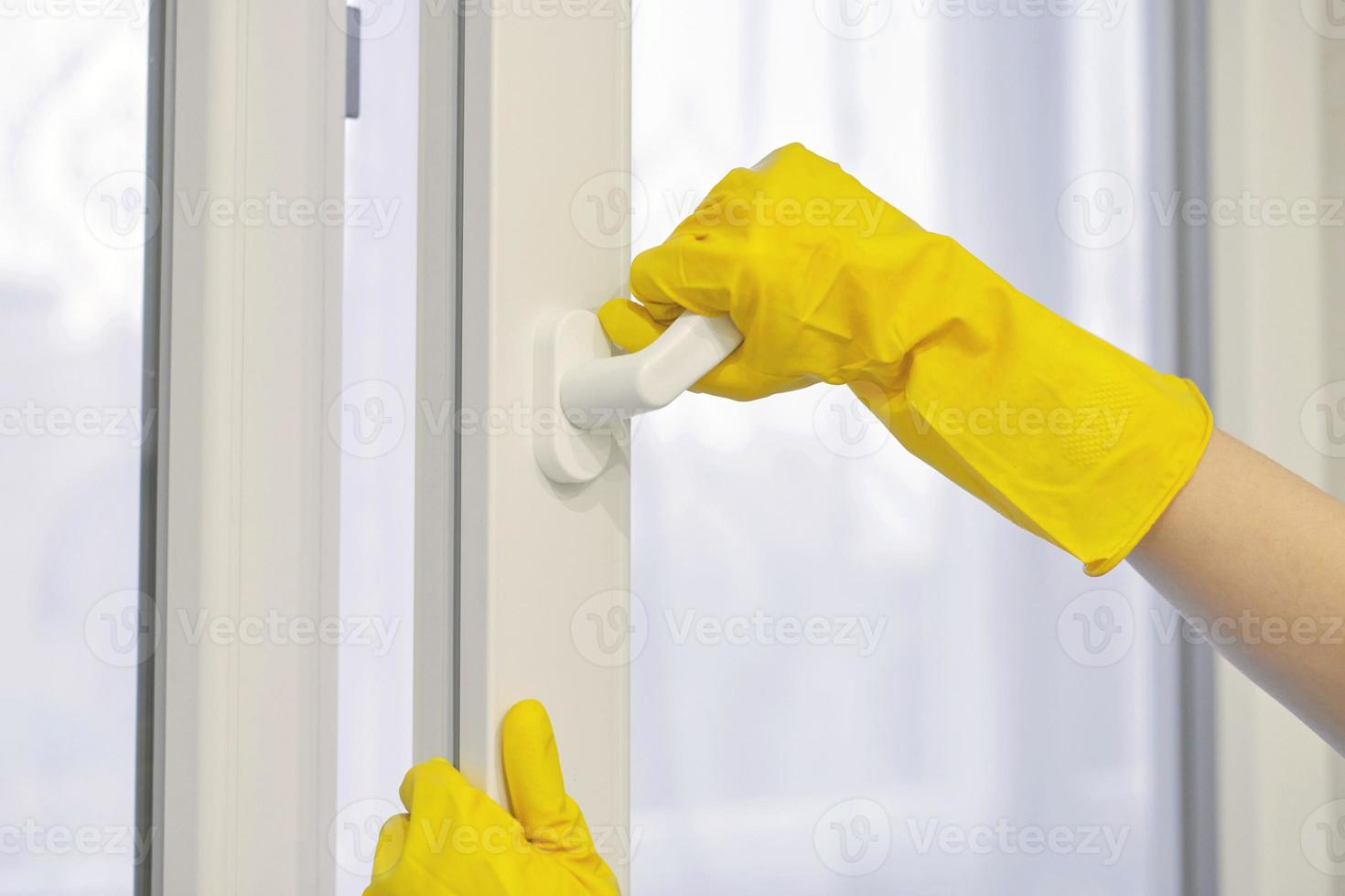 Hand in protective glove opens and closes window. photo