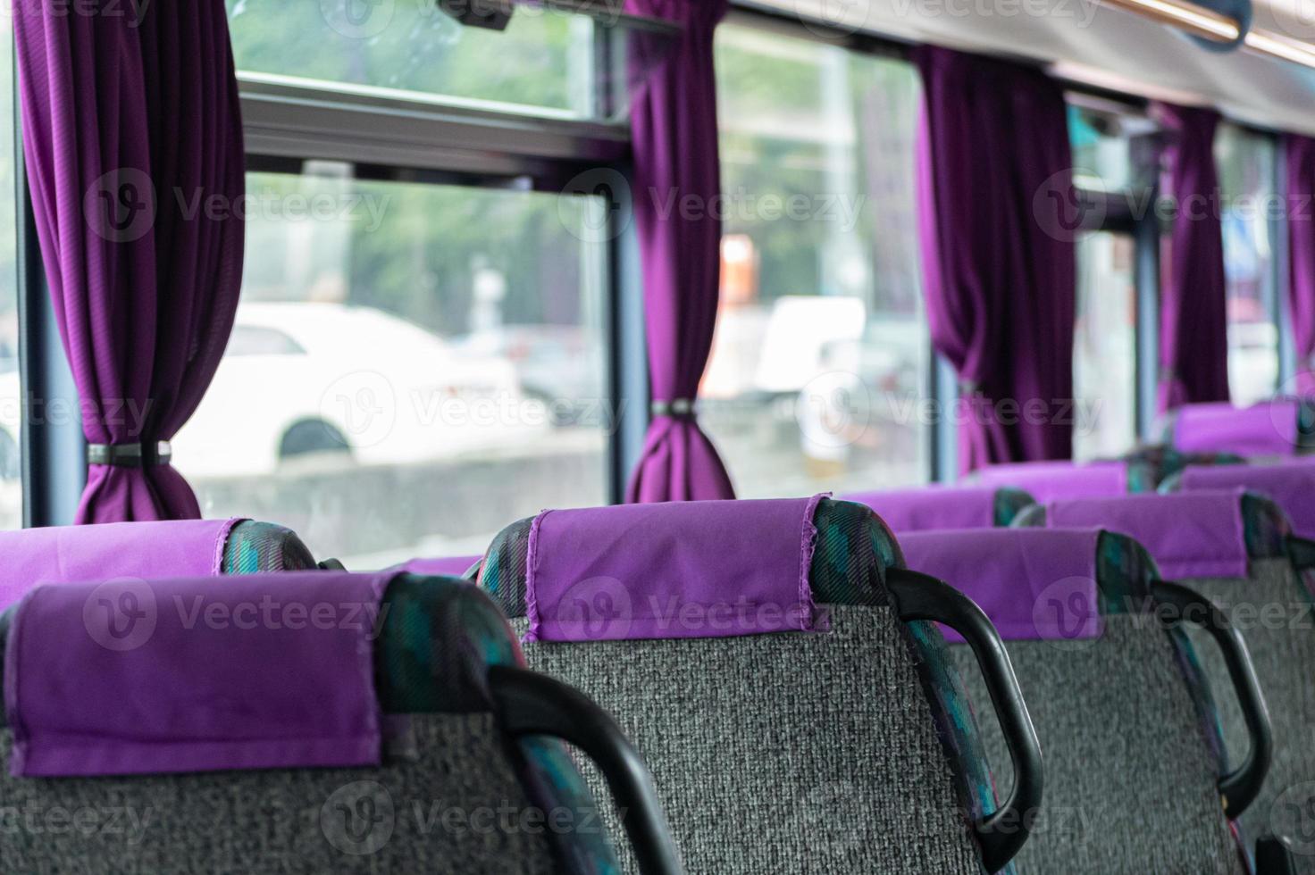 Comfortable bus seats backs without passengers. Intercity coach services. New bus interior with seat belts on each place. photo