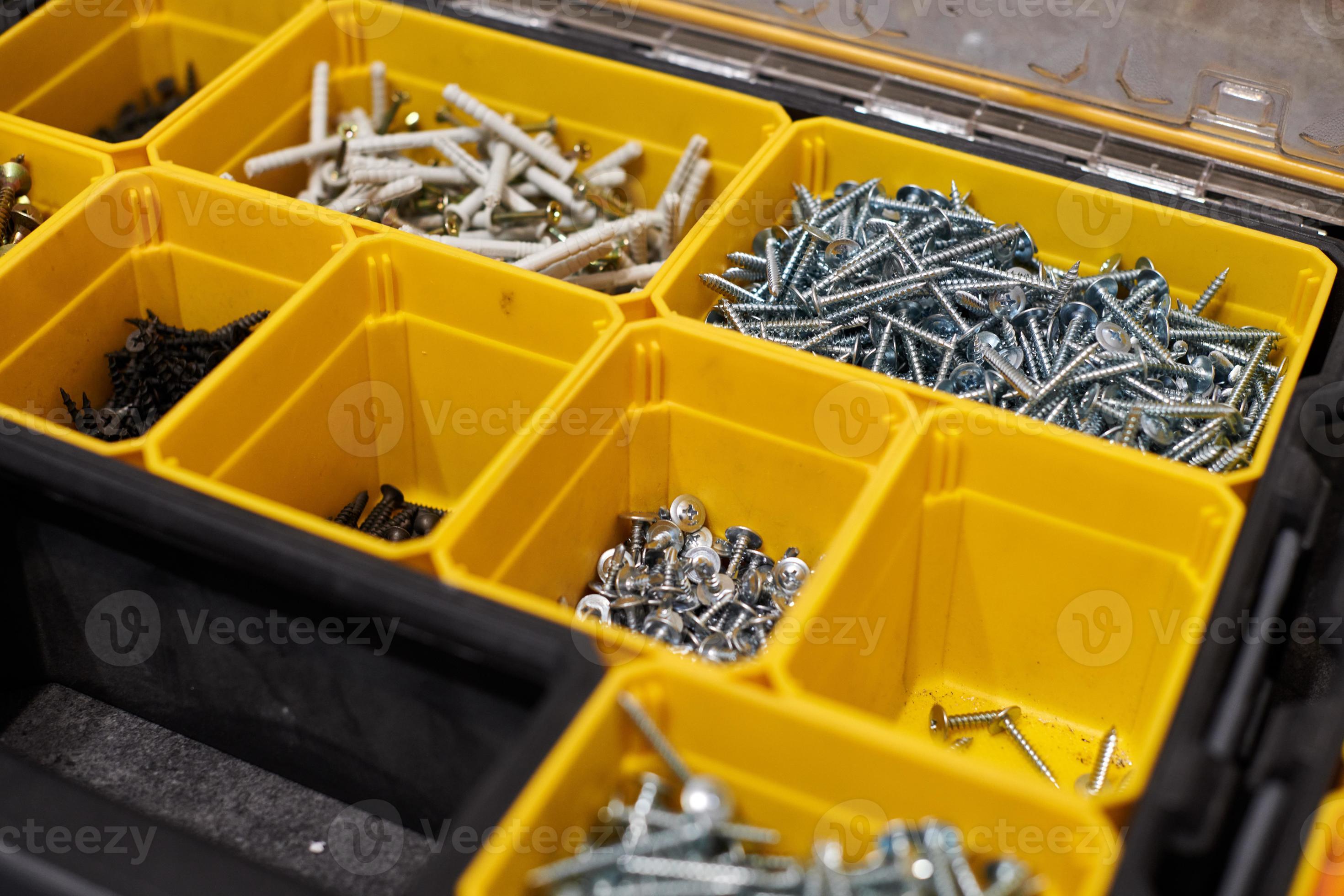 Yellow storage case with screws, nuts, bolts, nails and other small tools  for handyman, close up 12799187 Stock Photo at Vecteezy