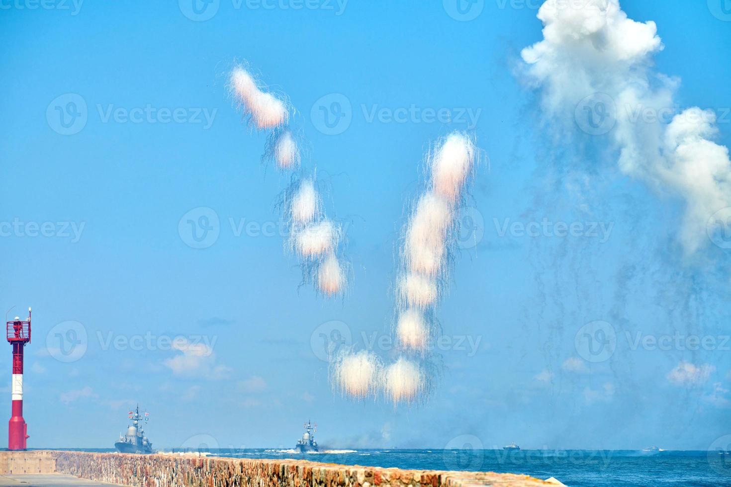 White carbon fiber clouds in blue sky hiding naval destroyers from anti-ship missiles, military show photo