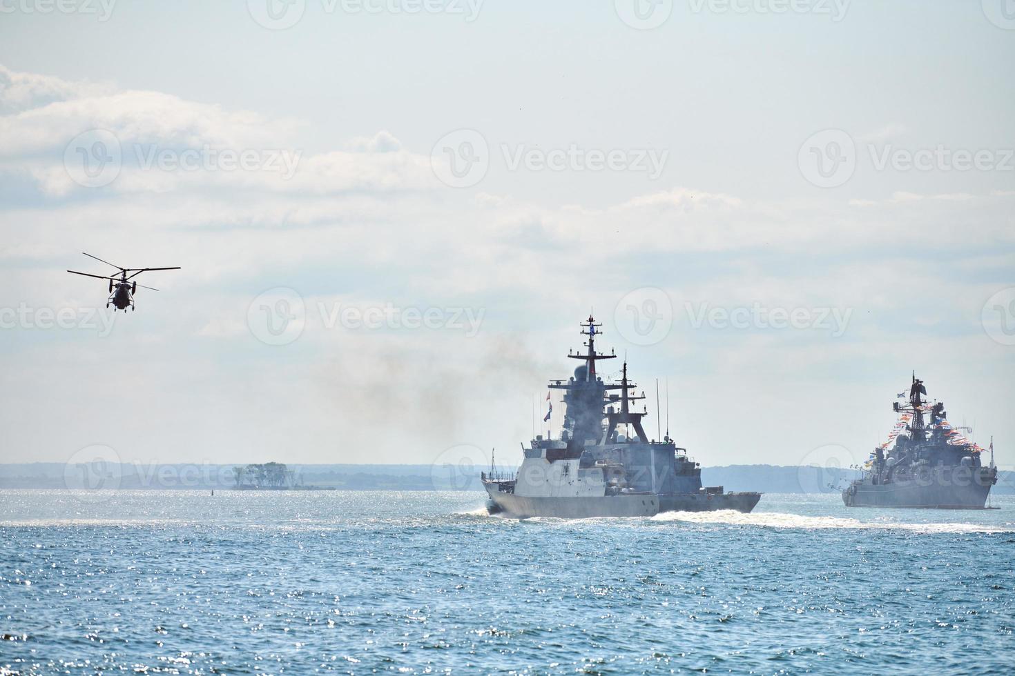 Battleships war ships corvette during naval exercises and helicopter maneuvering over sea, warships photo