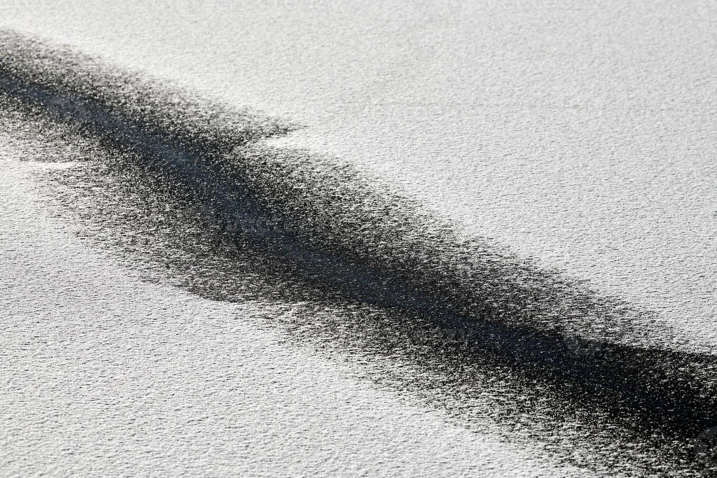 Abstract black line on snow-white background. Cracked ice photo