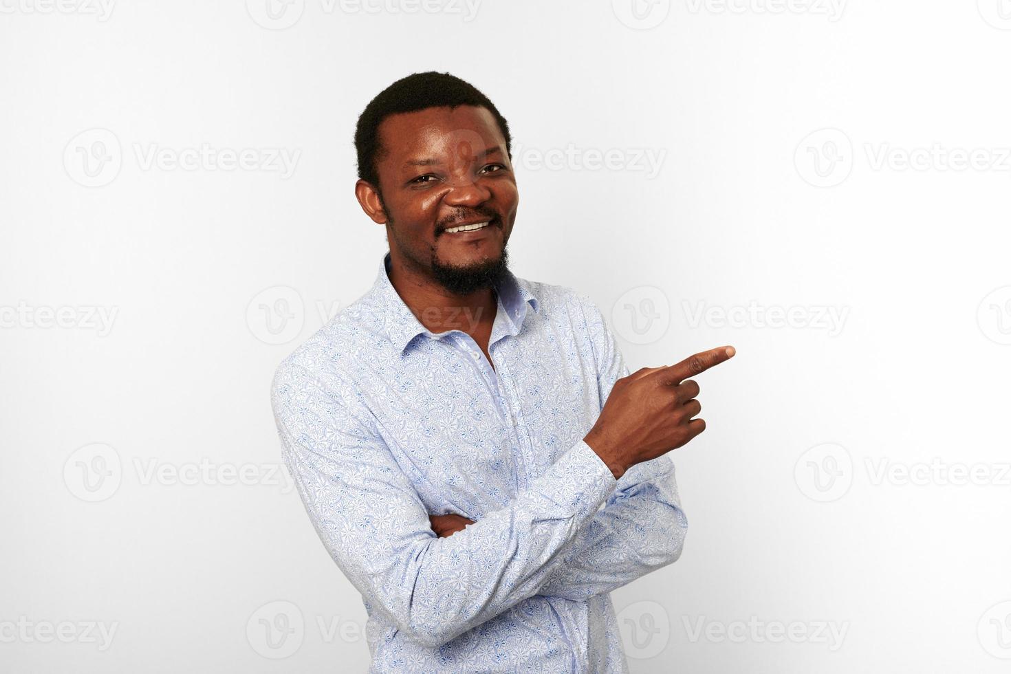 Happy african american black man with pointing finger in casual bright shirt isolated background photo