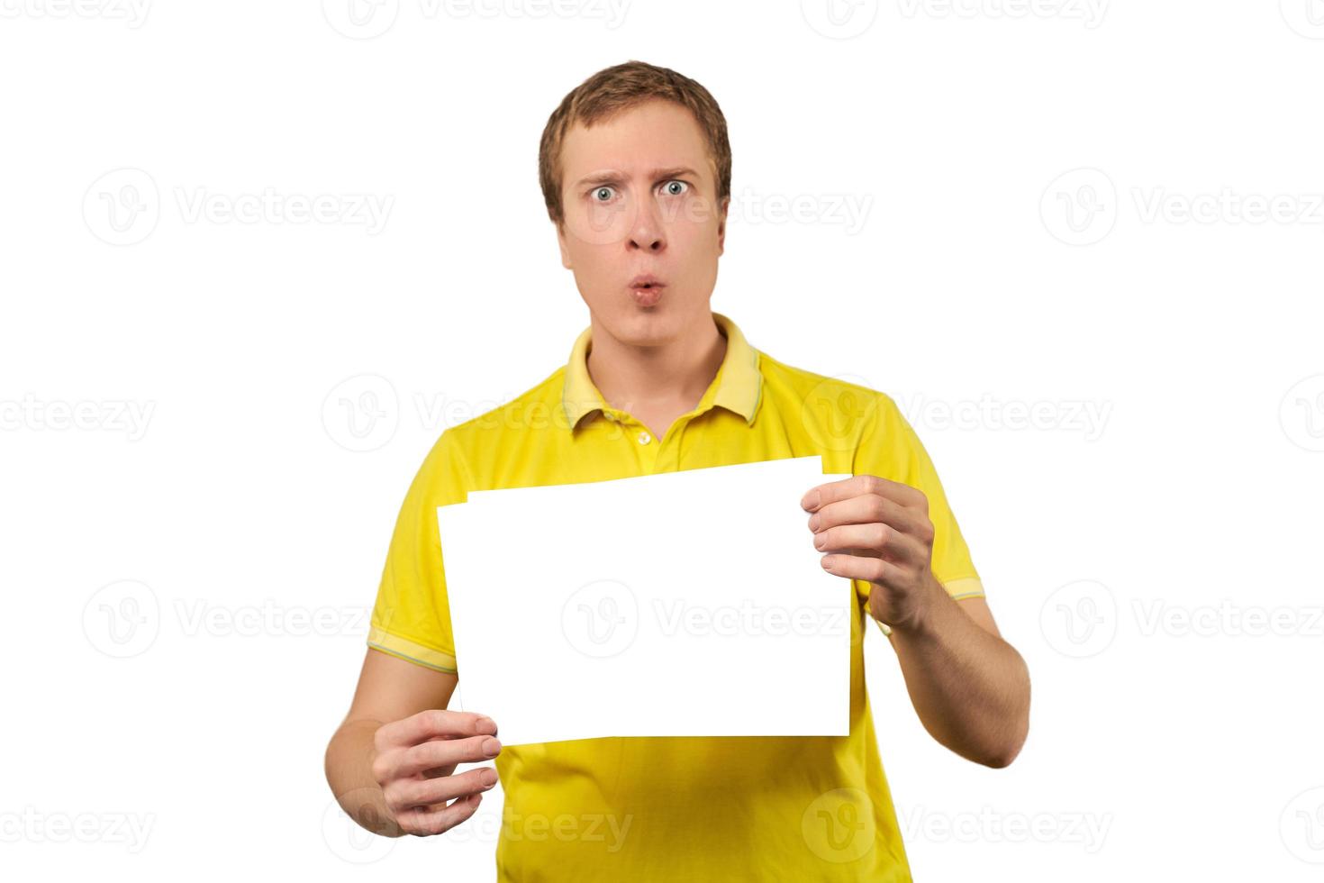 Surprised young man holding blank paper sheet, paper mockup isolated on white background photo