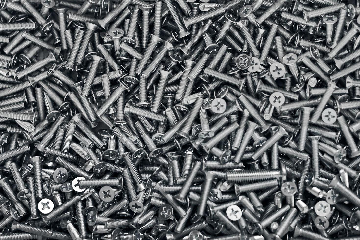 Bunch of galvanized stainless bolts with flat countersunk head, hardware background, silver screws photo