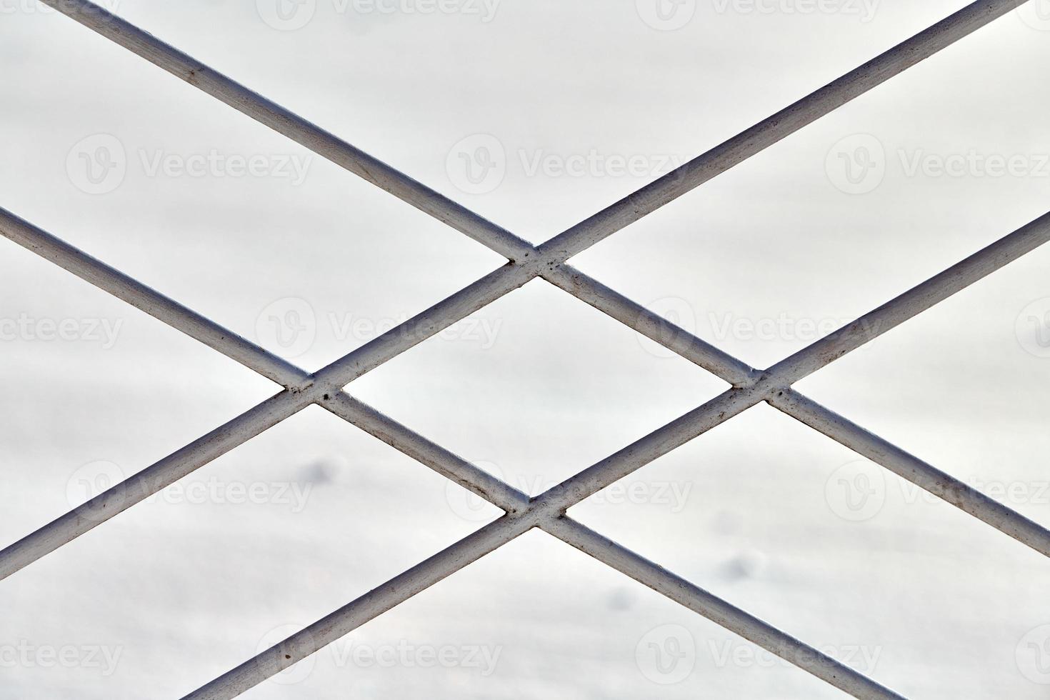 Metal fence with rhombus ornament on grey background photo