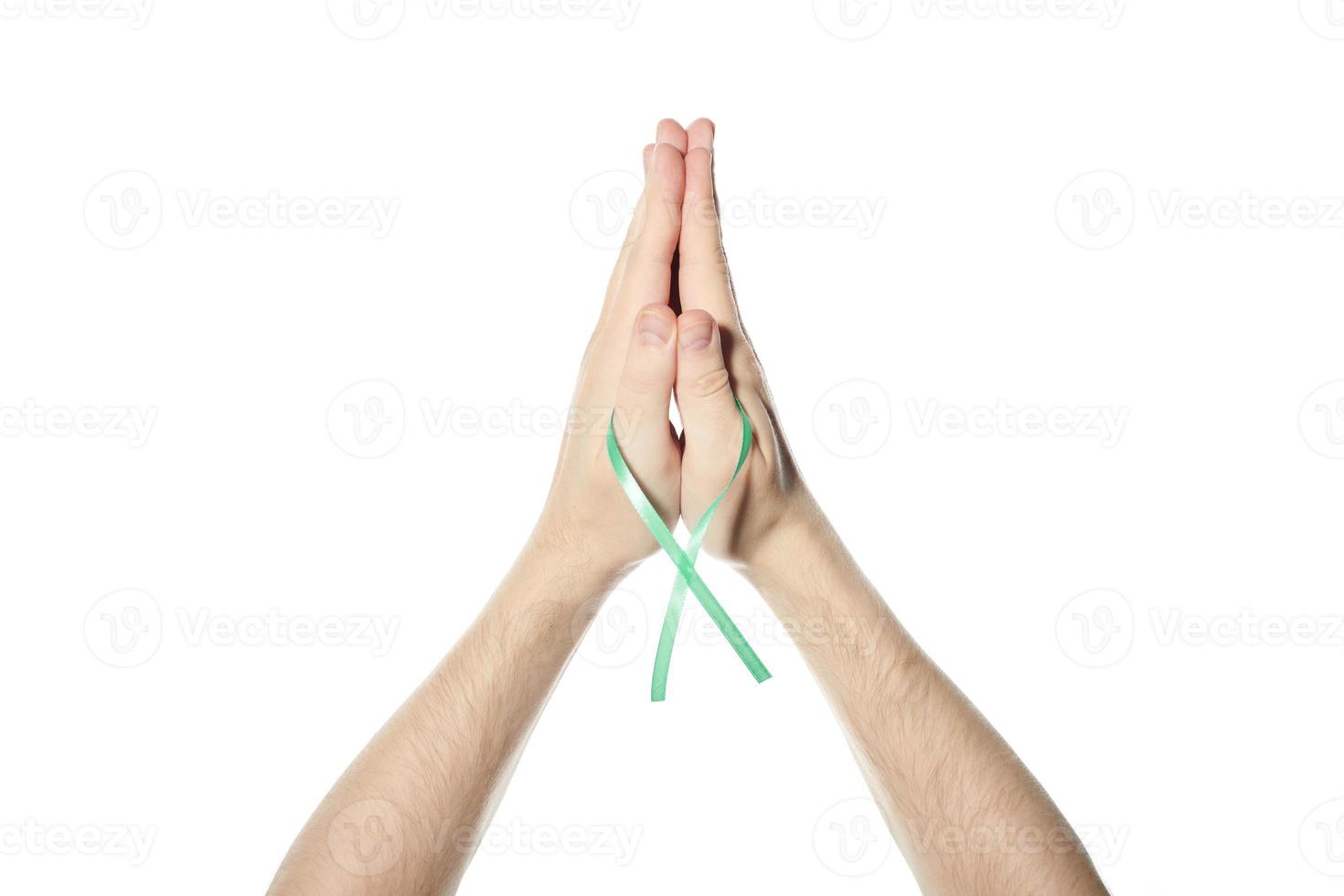 Green awareness ribbon in hand photo
