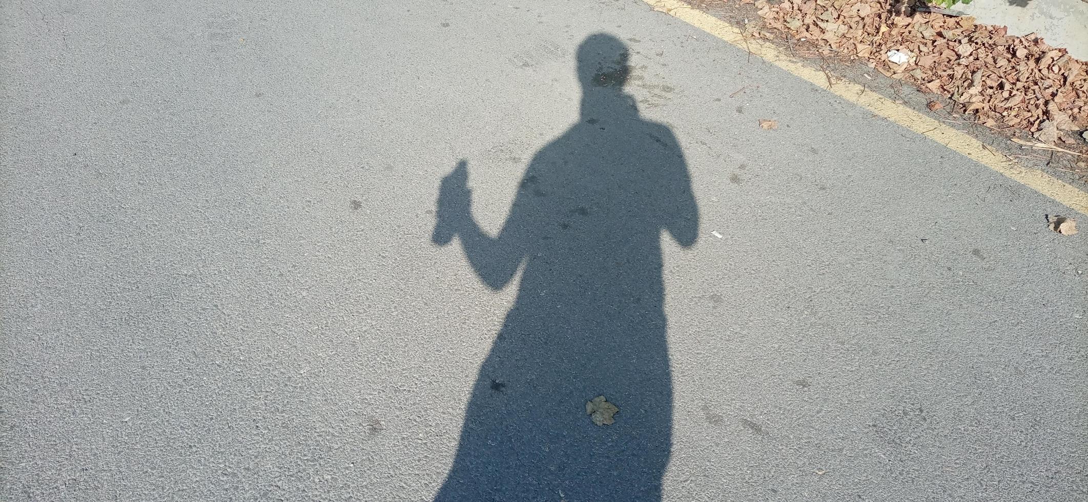 Human silhouette holding water bottle photo