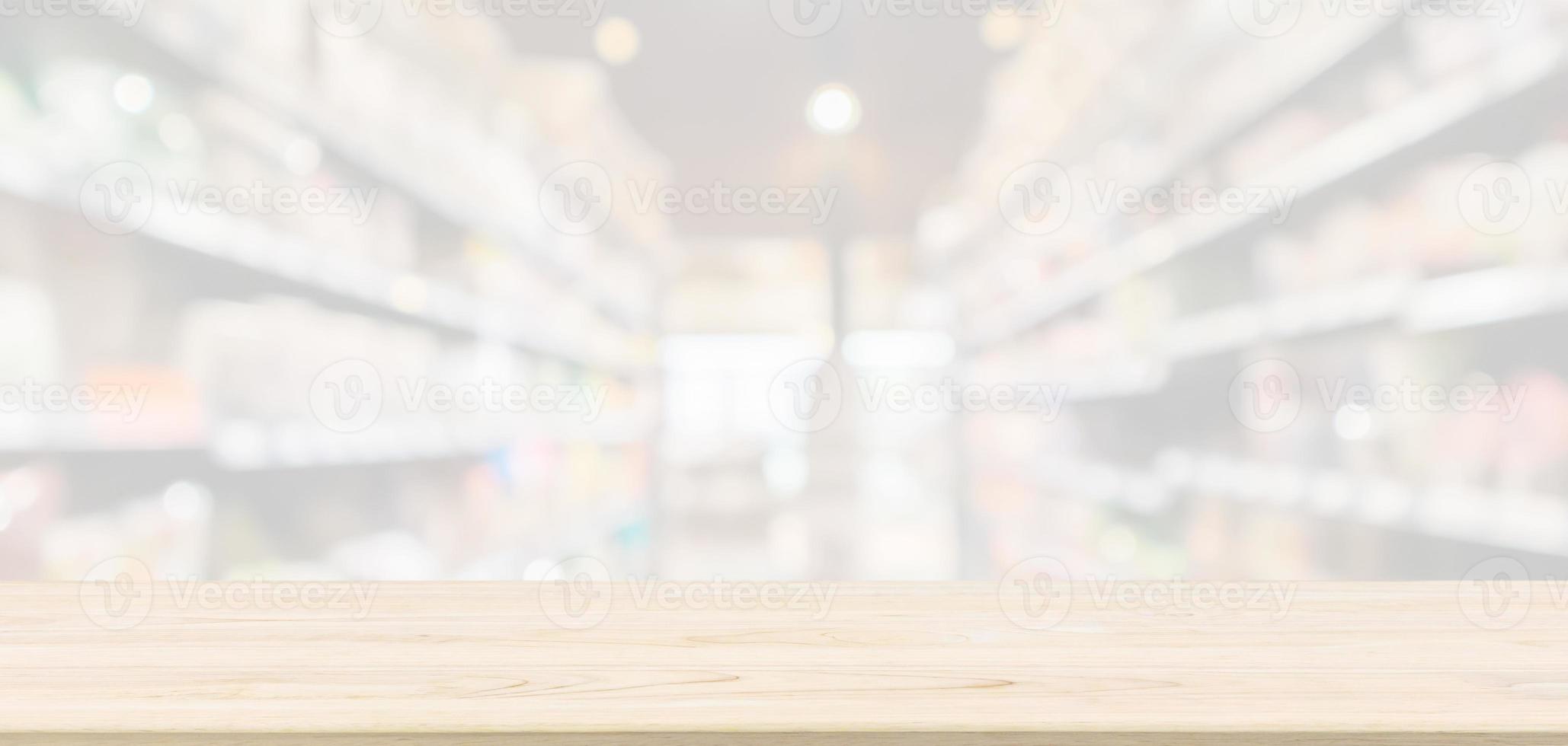 Empty Wood table top with supermarket grocery store aisle blurred defocused background with bokeh light for montage product display photo
