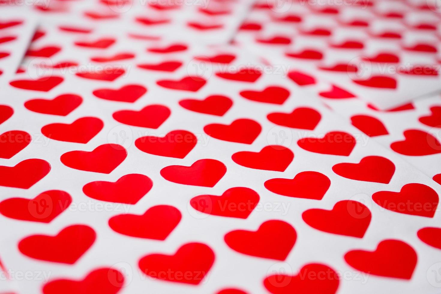 Close up red heart sticker on white paper photo