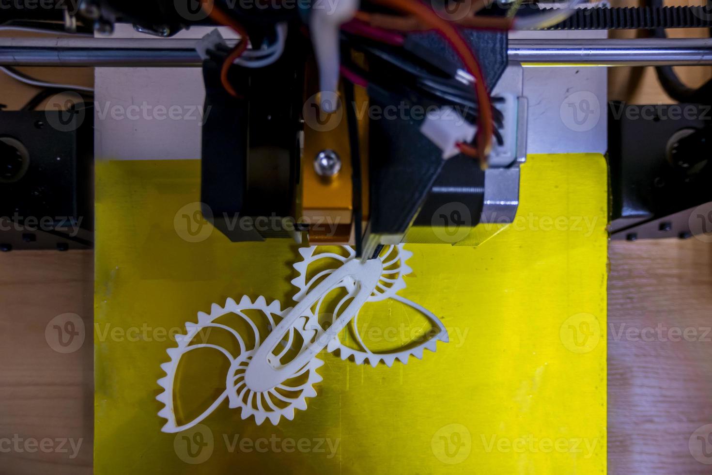 Modern 3D printer printing figure close-up macro 3d printer prints with orange plastic photo