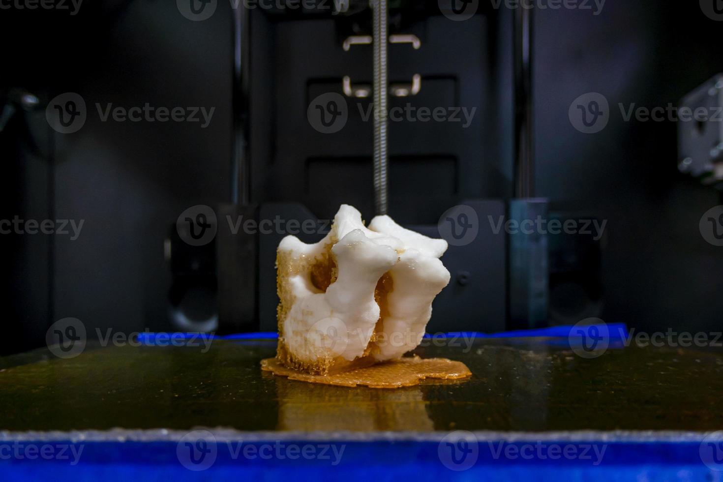 Modern 3D printer printing figure close-up macro 3d printer prints a vertebra photo