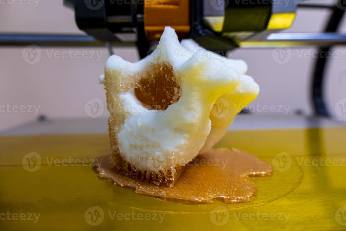 Modern 3D printer printing figure close-up macro 3d printer prints a vertebra photo