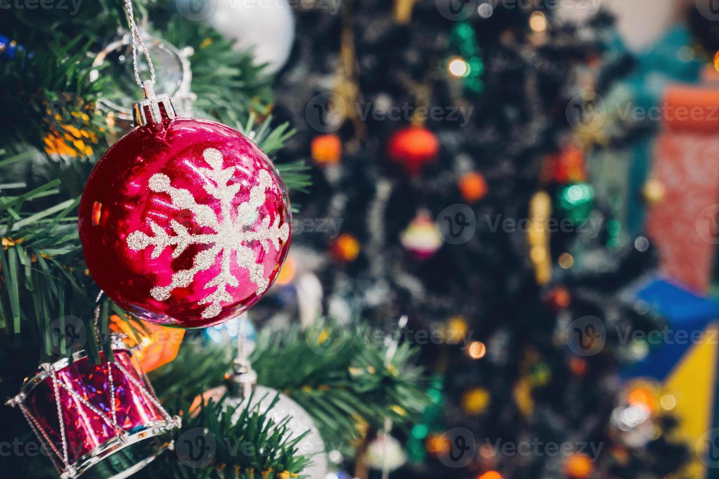Decorated Christmas tree with colorful bauble on sparkling bokeh light blurred background photo