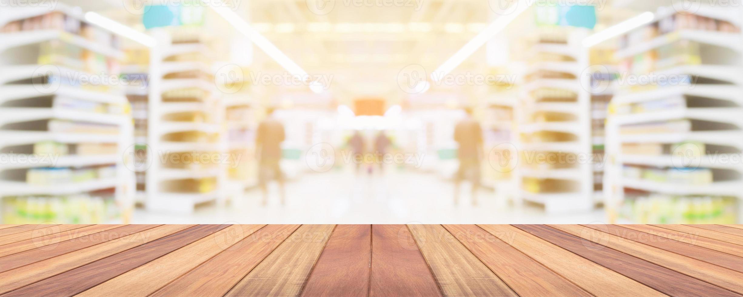 Wood table top with supermarket grocery store aisle interior blurred background with bokeh light for product display photo