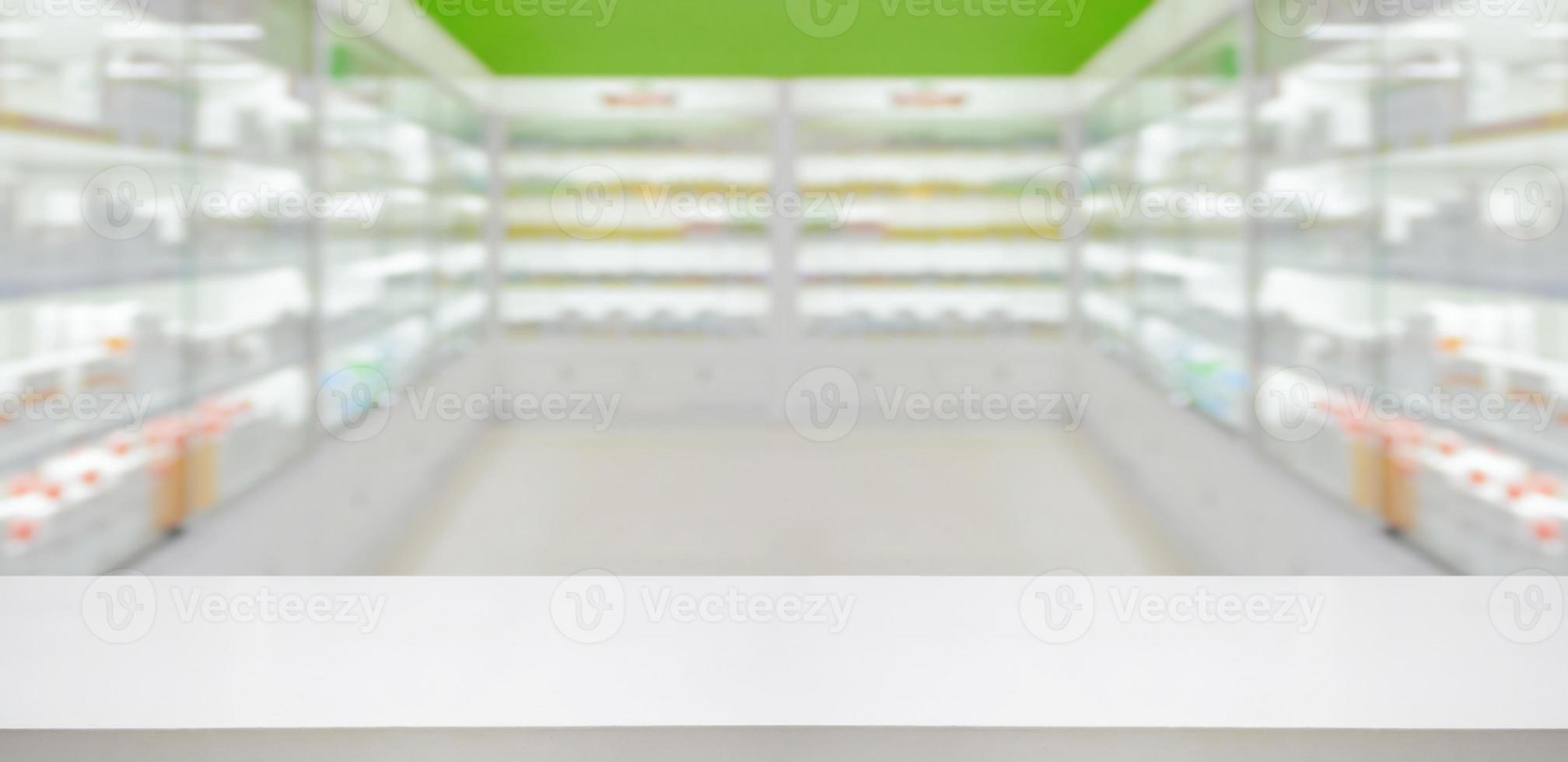 Empty white counter with pharmacy drugstore shelves blurred background photo