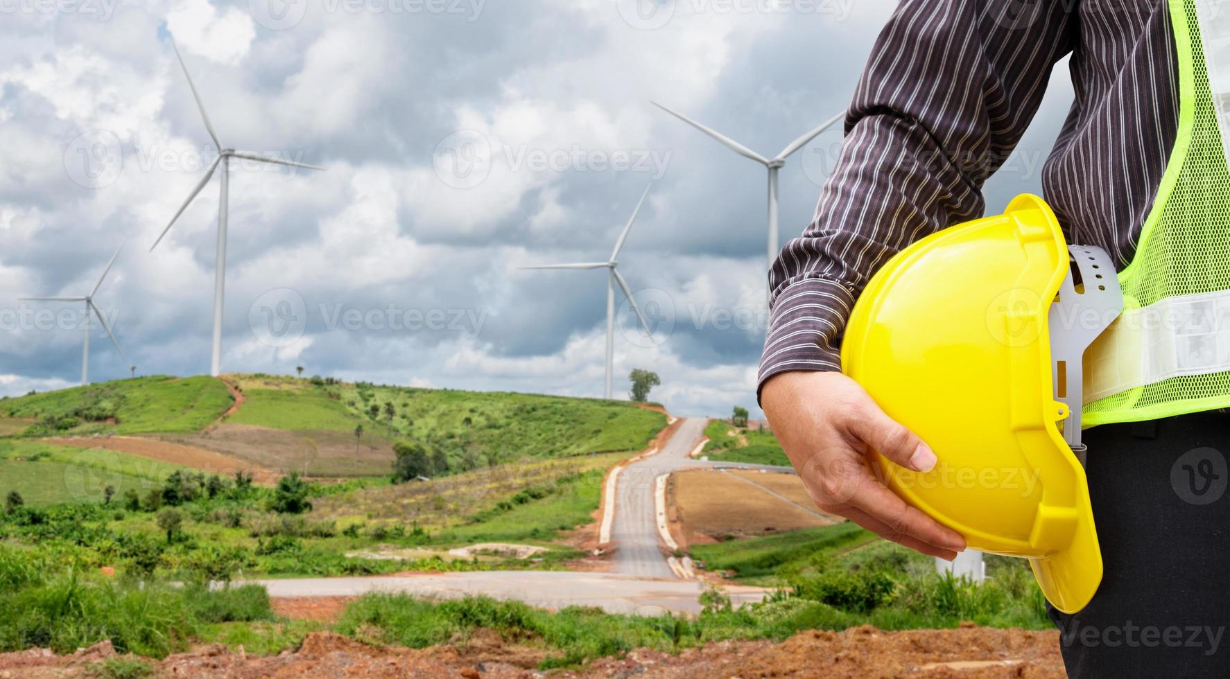 Engineer worker at wind turbine power station construction site photo