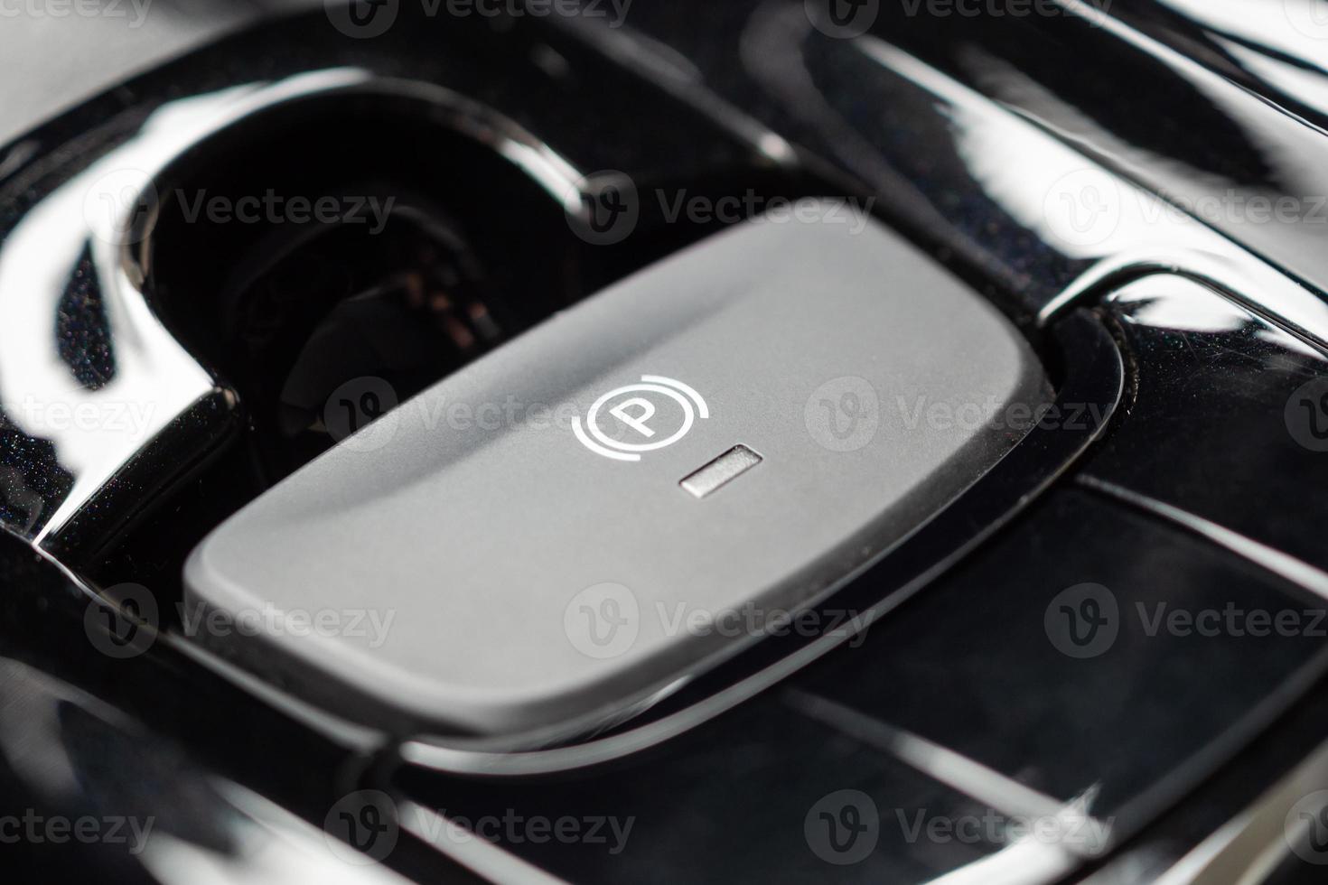 electronic handbrake button in luxury modern car photo