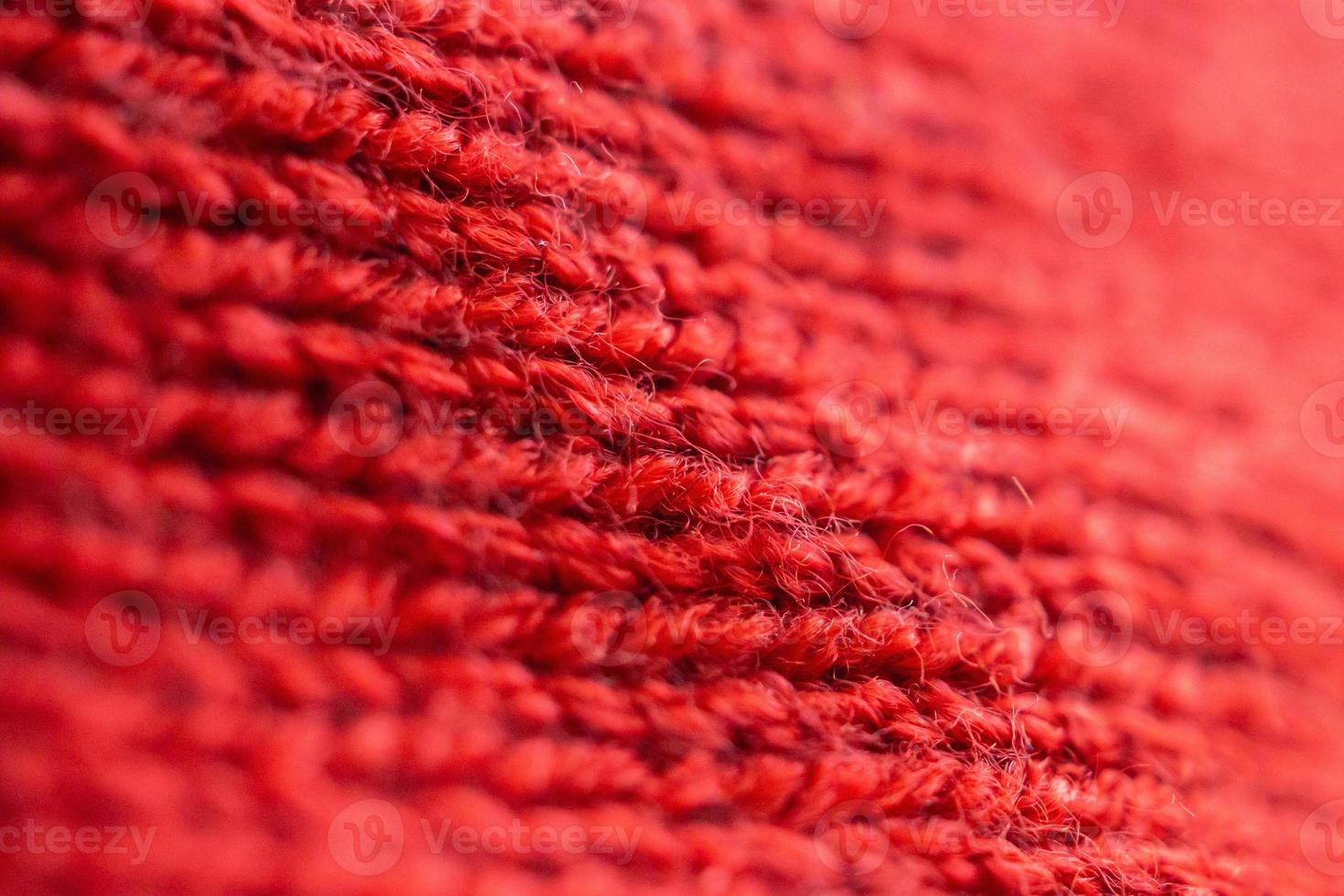 closeup red knitted woolen fabric texture background photo