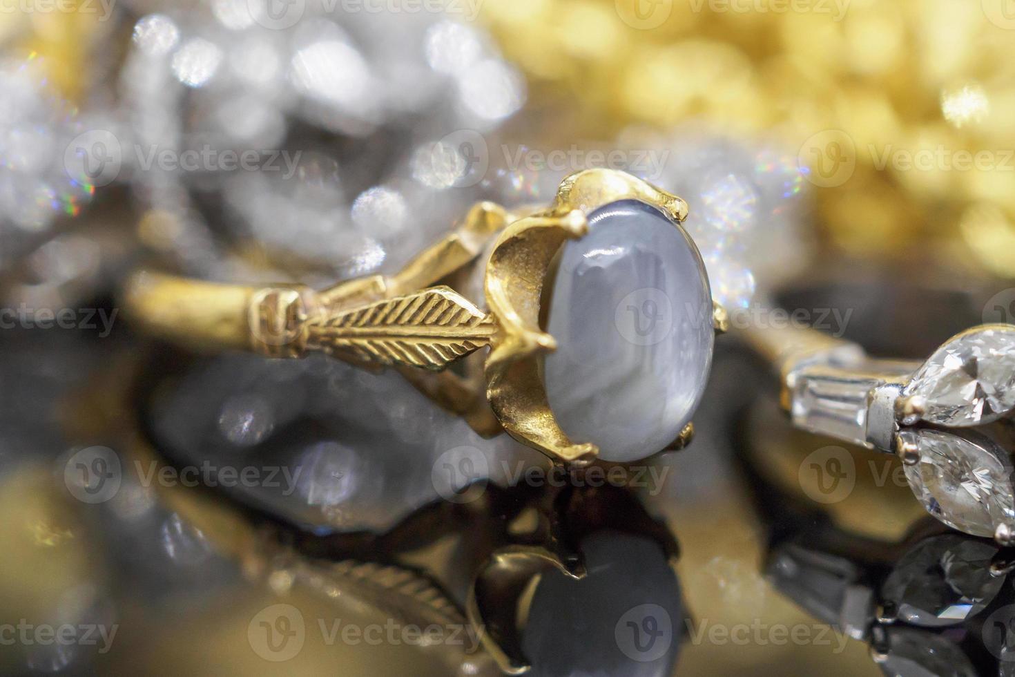 Vintage gold Jewelry blue sapphire rings with reflection on black background photo