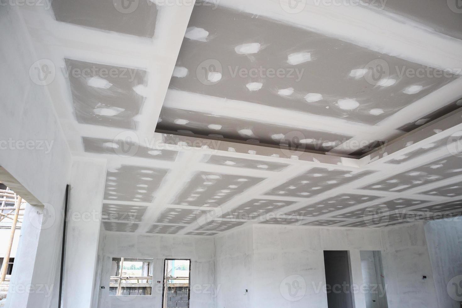 ceiling gypsum board installation at construction site photo