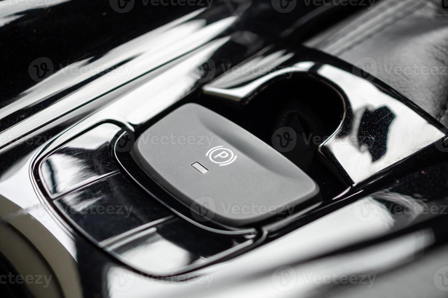 electronic handbrake button in luxury modern car photo